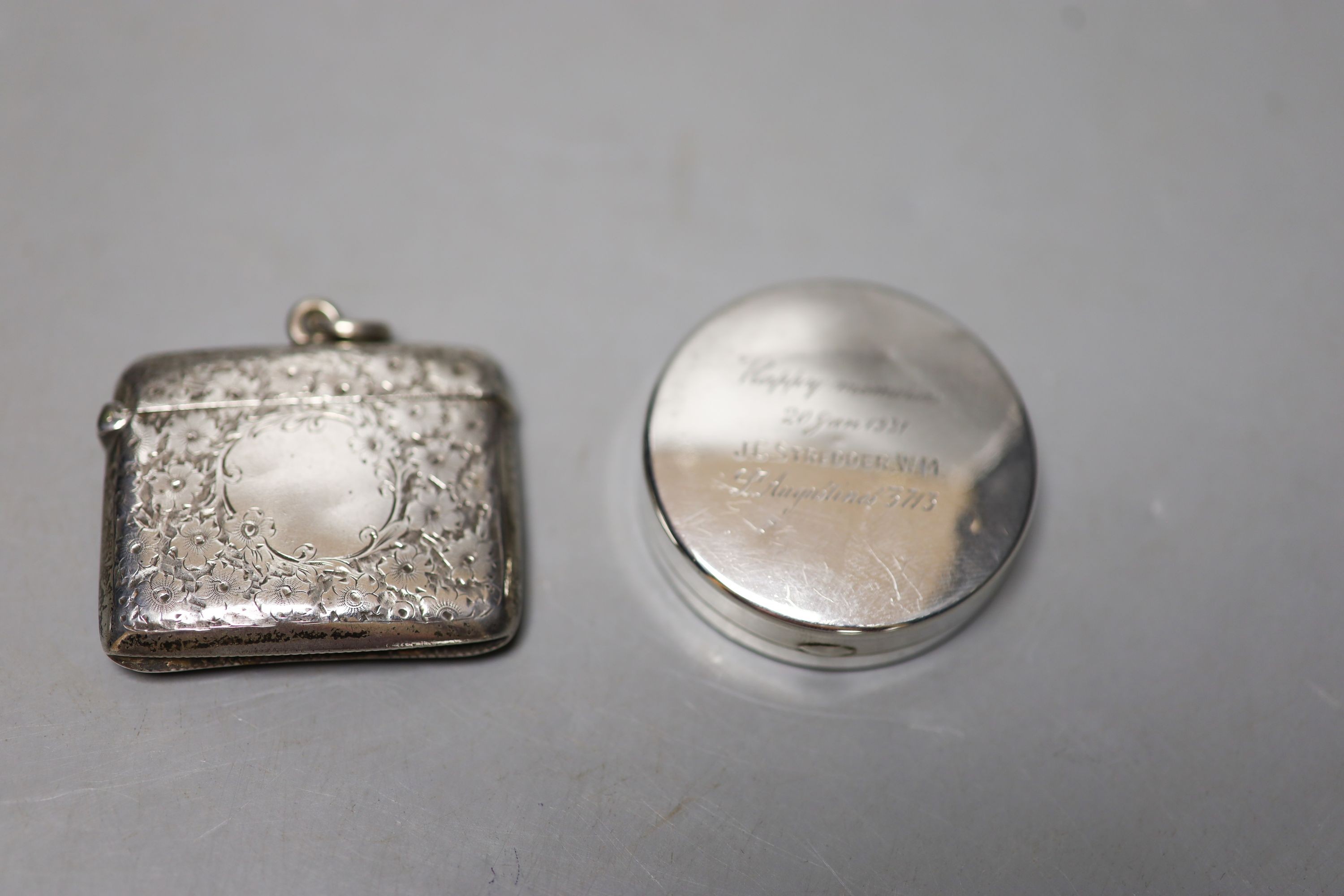 Two silver cigarette cases, largest 10.8cm, a silver vesta case, circular pill box, ashtray and dish.